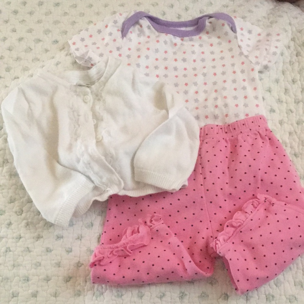 White cardigan, flower onesie, & polka dot pants.